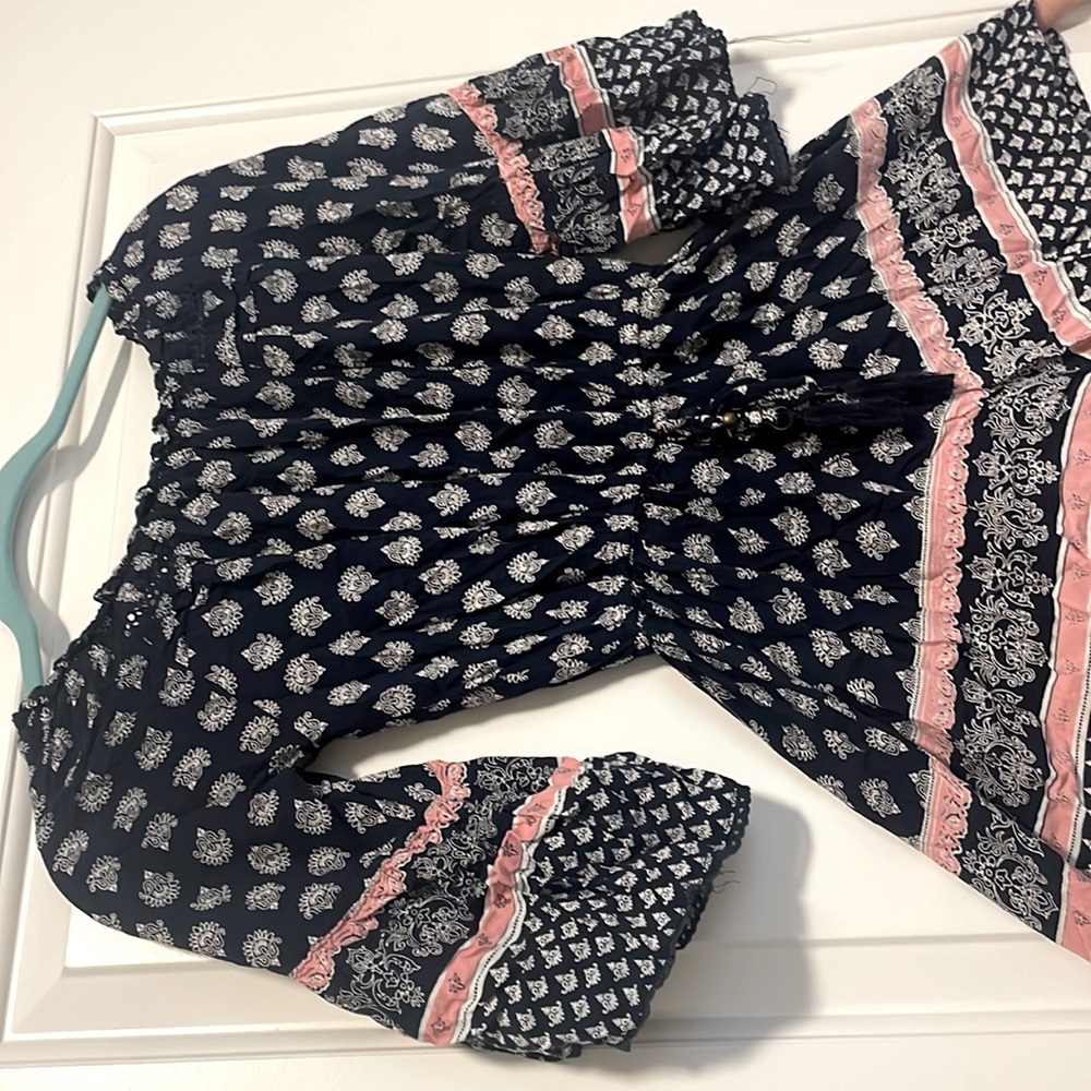 pink, blue, and white romper with belt tie to tighten or stretch.